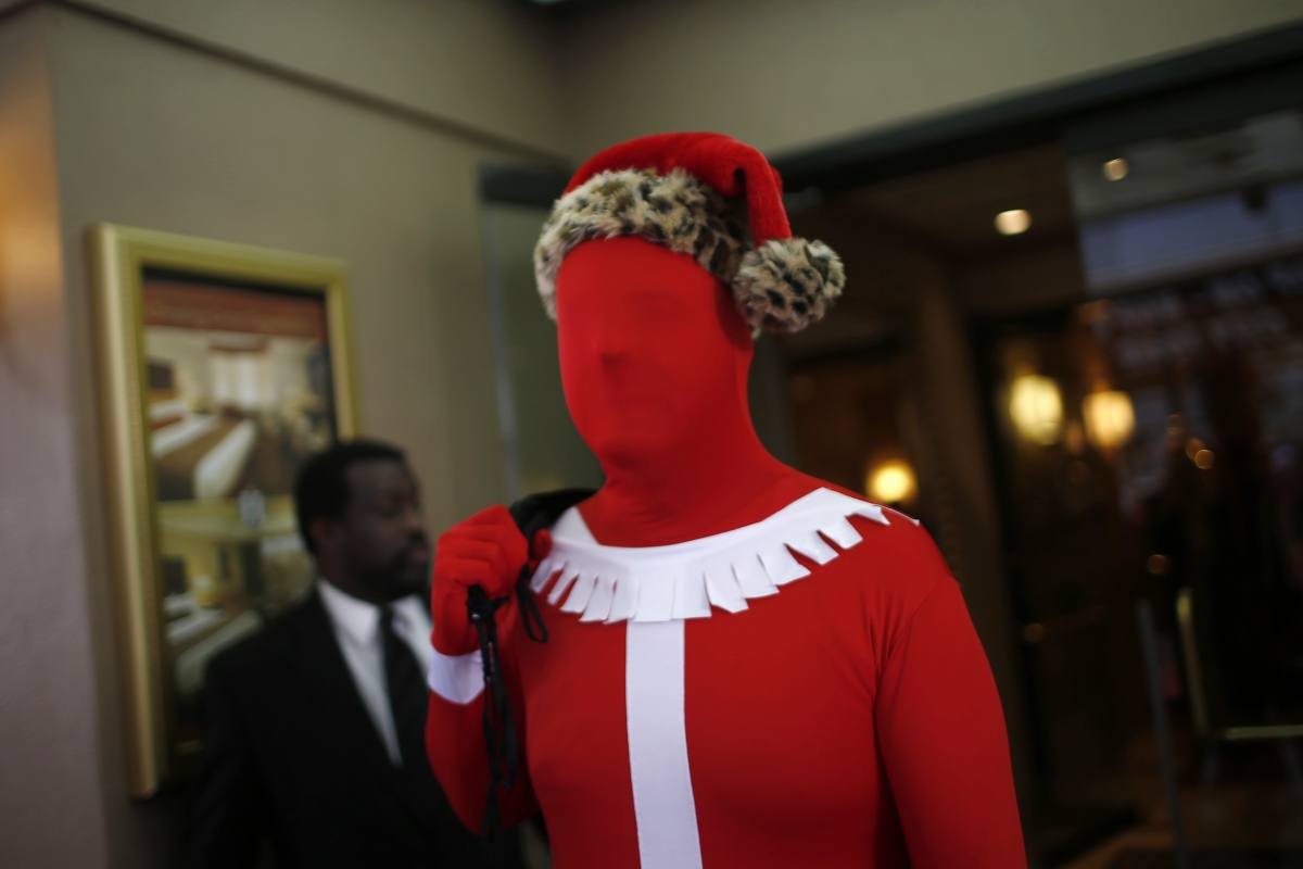 Creepy and disturbing but strangely festive. A fan of the Morphsuit at the annual SantaCon event in San Francisco. Creepy and disturbing but strangely festive. A fan of the Morphsuit at the annual SantaCon event in San Francisco.