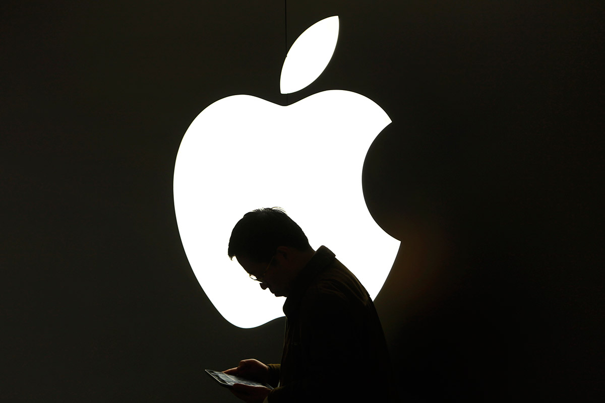A man looks at his iPad outside an Apple store in Shanghai apple ipad ereader