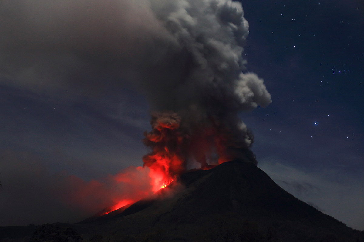 Mount Sinabung is seen during an eruption, from Naman Teran village in Karo district. sinabung glowing