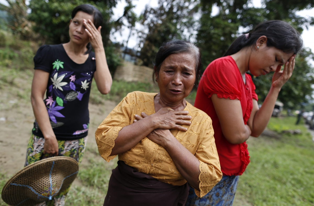 Muslim women react to the loss of their homes which were burnt down in violence in Pauktaw village