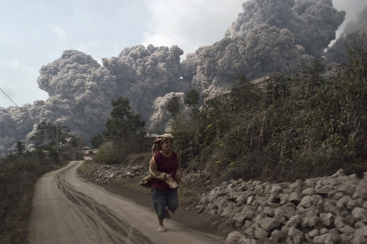 A villager runs as Mount Sinabung erupts at Sigarang-Garang village in Karo district. Indonesia volcanic eruption in pictures