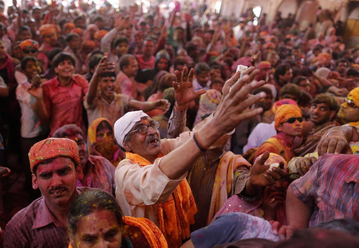 Hindu devotees daubed in colours gather at the Radhe-Krishna temple to celebrate Lathmar Holi.