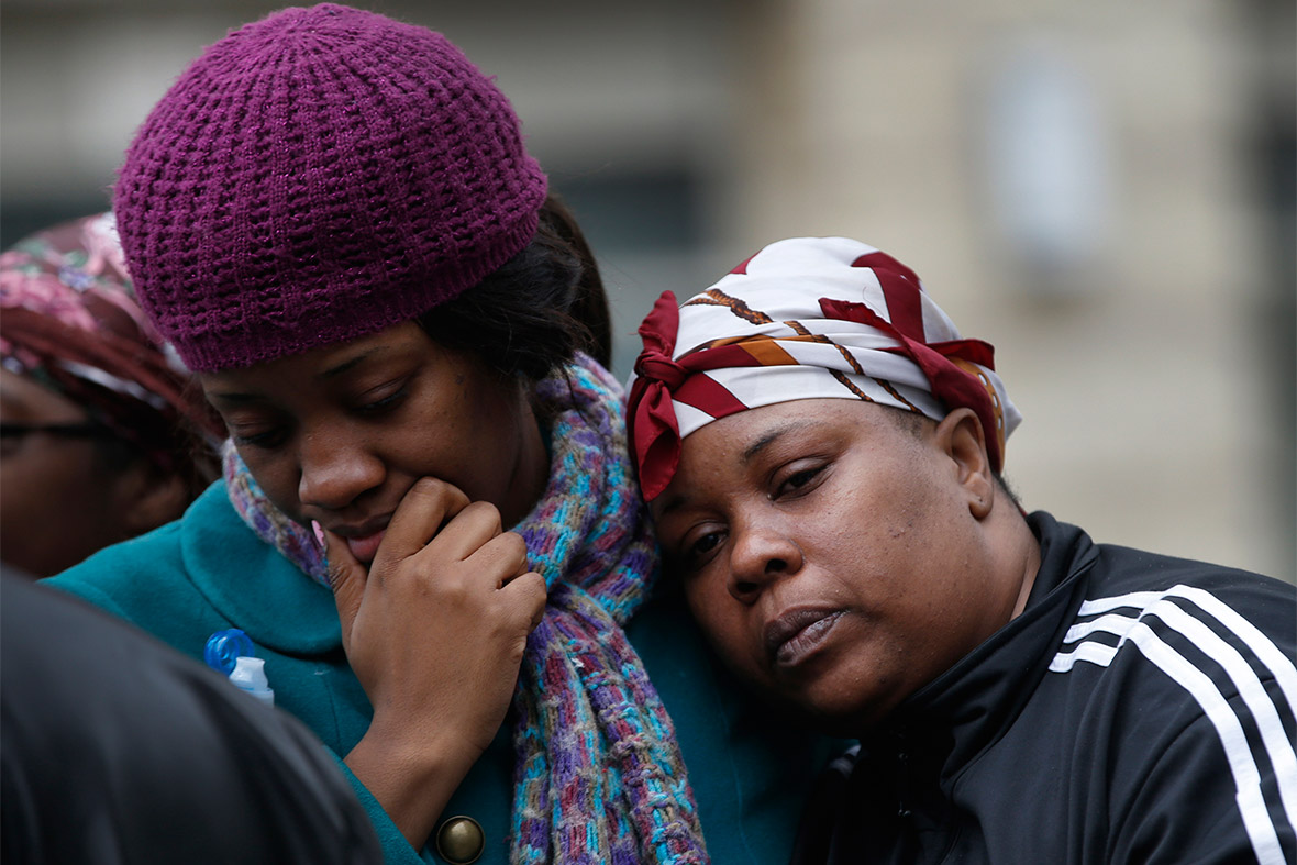 Alicia Thomas (left), who lived in one of the two buildings destroyed in an explosion in the East Harlem section of New York City, is comforted by her friend Shivon Dollar