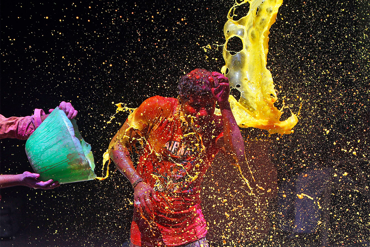 Coloured water is thrown at a man during Holi, the Festival of Colours, in the southern Indian city of Chennai