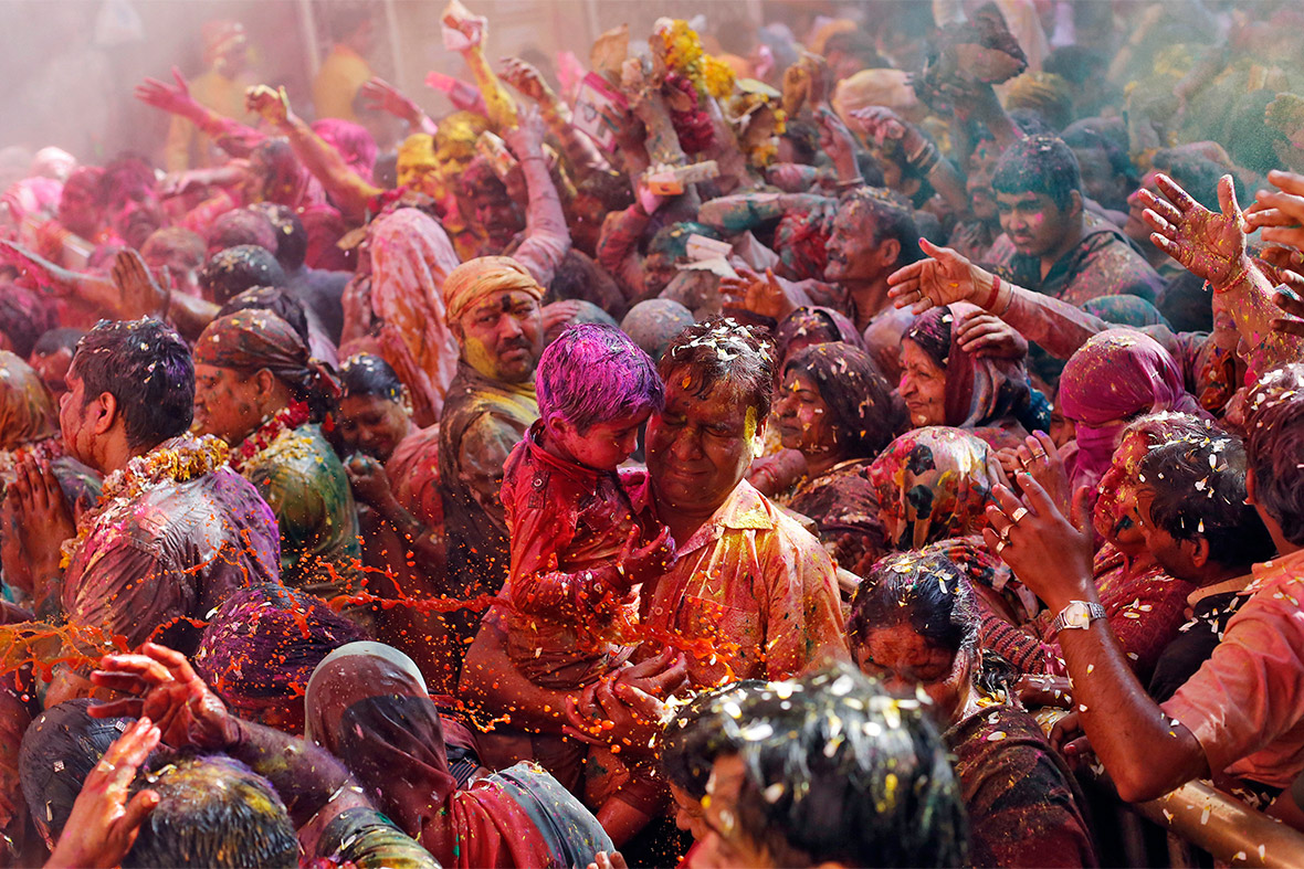 People are splattered with colour during Holi celebrations at the Bankey Bihari temple in Vrindavan