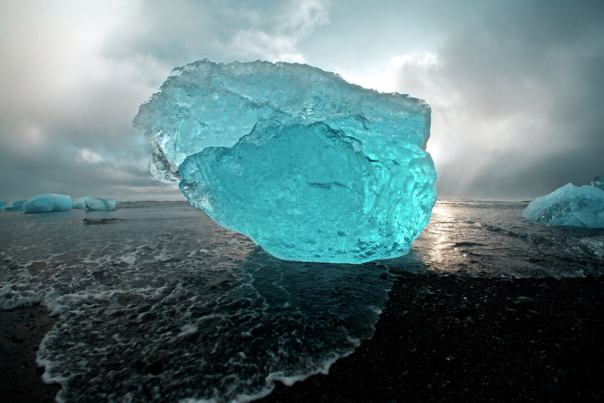 Huge iceberg sculptures on a volcanic black beach on the Jökulsárlón lagoon in Iceland