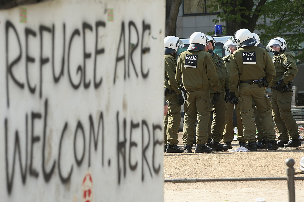 Riot police discuss the eviction operation refugees are welcome