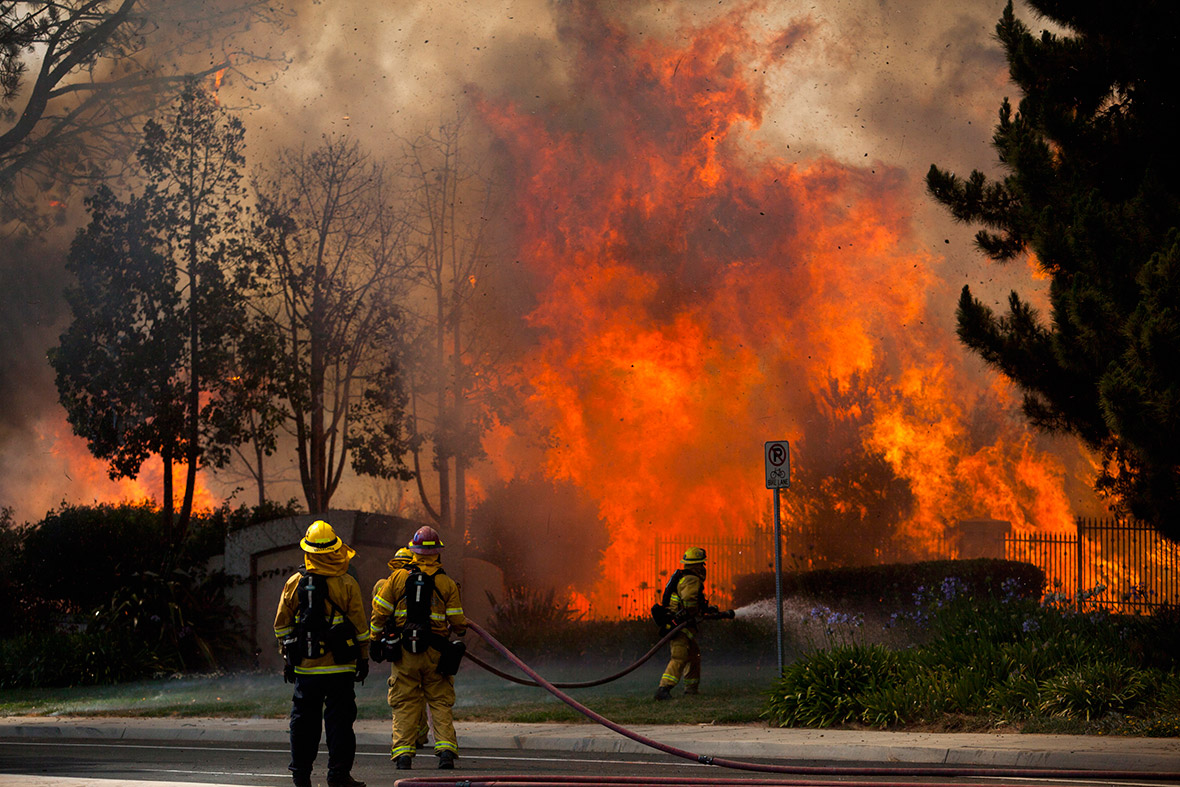 Firefighters tackle the Poinsettia fire in Carlsbad, California house flames