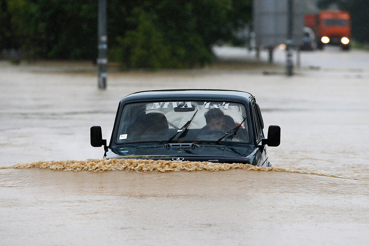 A man drives his car through a flooded street in the town of Lazarevac, south of the Serbian capital Belgrade. serbia car