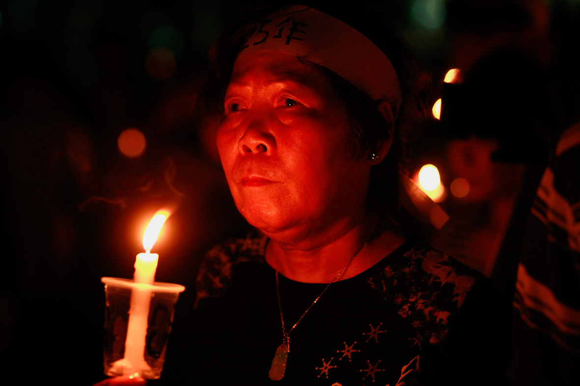 A woman mourns those killed at Beijing's Tiananmen Square in 1989, during a candlelight vigil in Hong Kong's Victoria Park