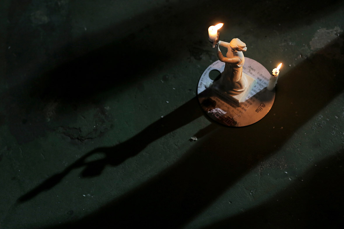 A miniature Goddess of Democracy candlestick is displayed during a vigil in Hong Kong
