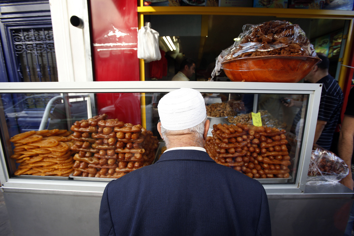 A man shops for traditional sweets for Iftar, or breaking of fast, during the Muslim month of Ramadan in Paris A man shops for traditional sweets during Iftar in Paris