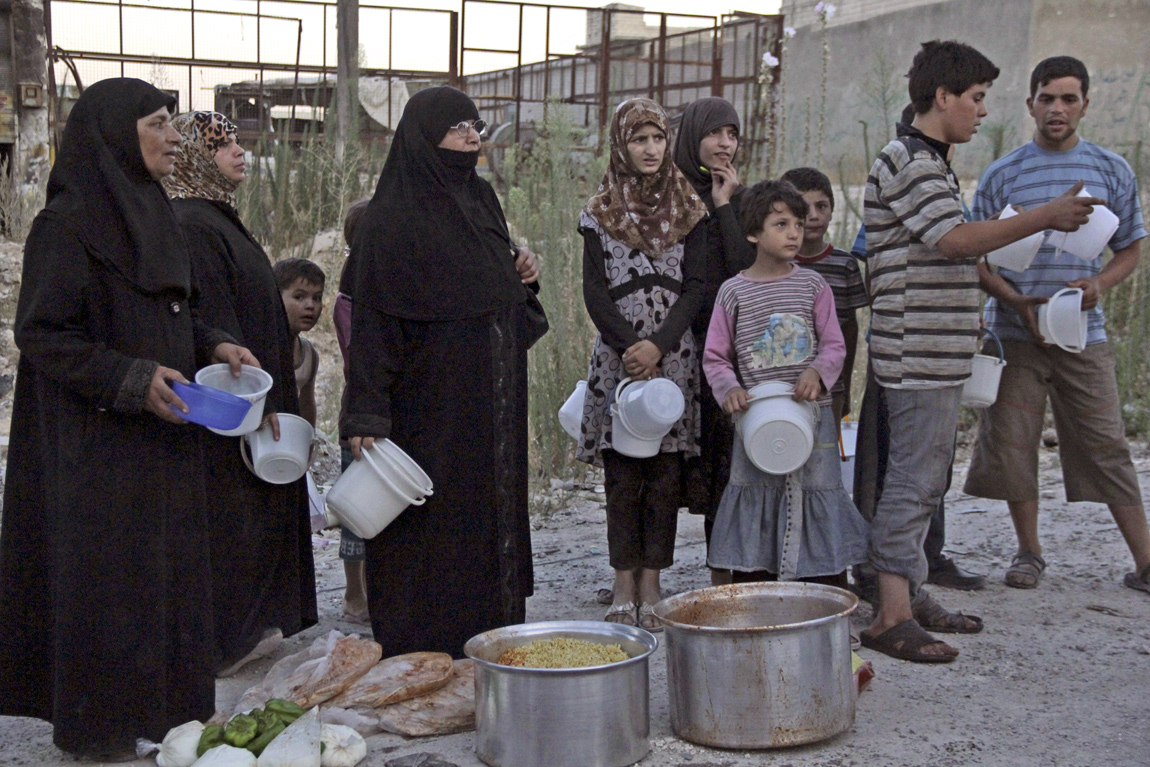 People wait for the time for the Iftar meal to break their fast in Aleppo, Syria People wait for the time for the Iftar meal to break their fast in Aleppo, Syria