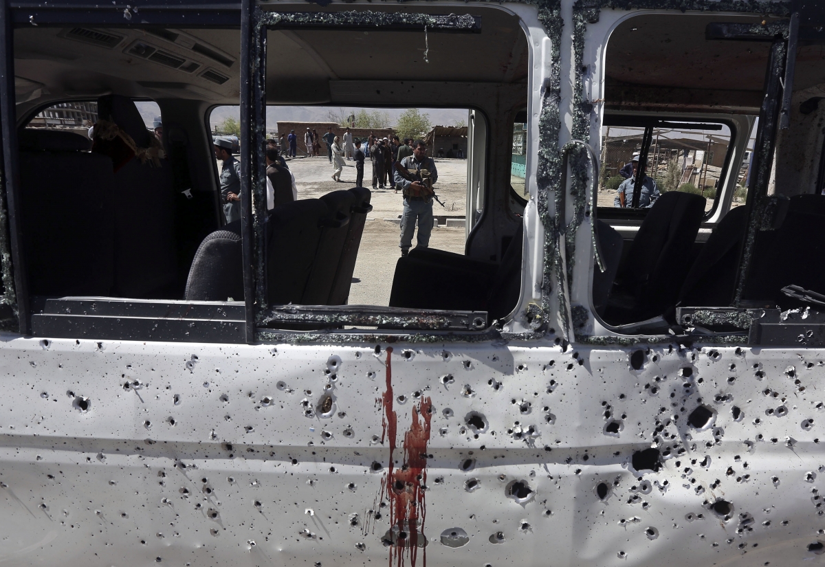 An Afghan policeman is seen through the broken windows of a vehicle after it was hit by a remote-controlled bomb in Kabul Afghanistan Bomb