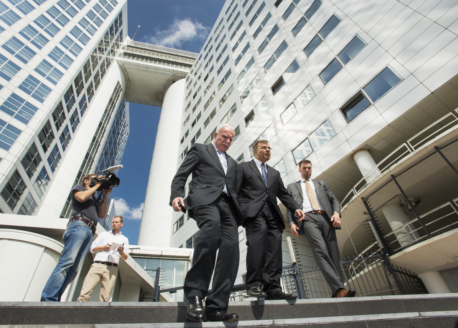Palestinian Foreign Minister Riad al-Malki (C) leaves the International Criminal Court (ICC) at the Hague