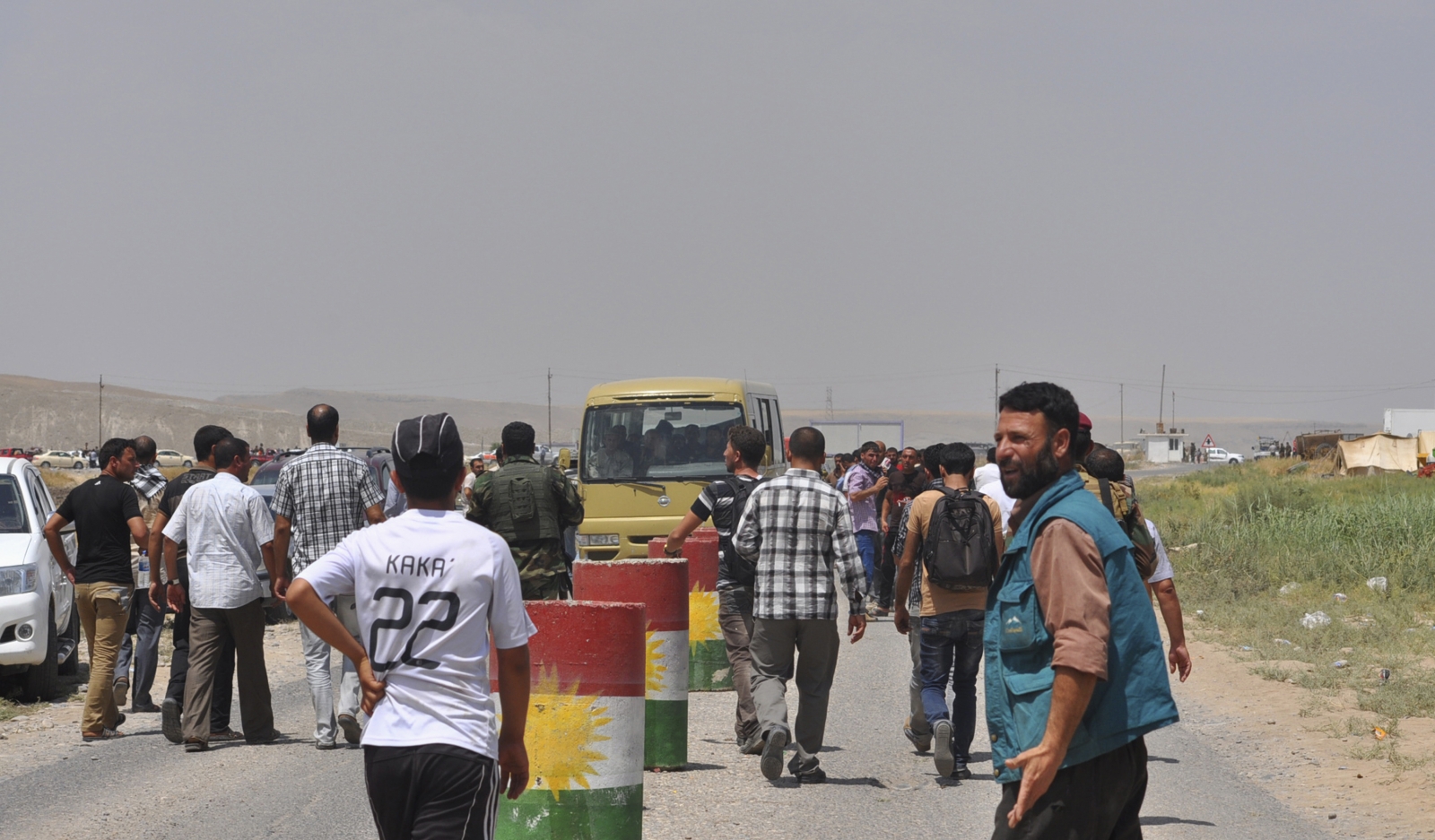 Displaced families from the minority Yazidi sect, fleeing the violence, walk on the outskirts of Sinjar, west of Mosul Displaced families from the minority Yazidi sect, fleeing the violence, walk on the outskirts of Sinjar, west of Mosul