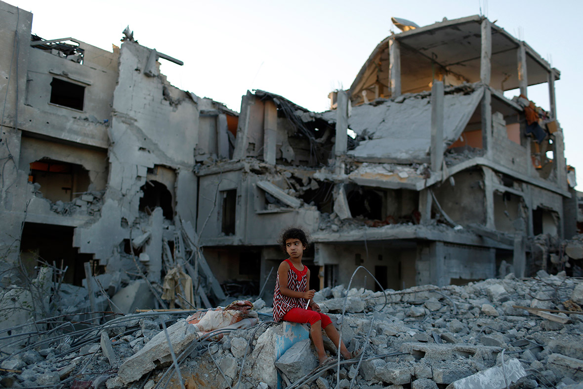 A girl sits on the ruins of her family's home in the Beit Hanoun neighbourhood of Gaza City(Siegfried Modola/Reuters)