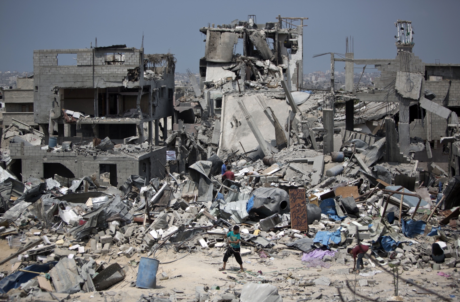 Palestinians walk on the rubble of their destroyed houses in the Tufah neighbourhood in eastern Gaza City. Gaza devastation rubble