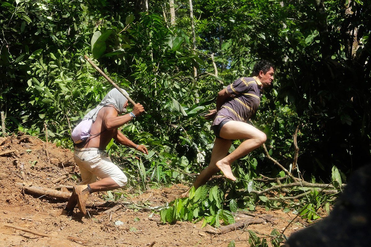 A Ka'apor warrior chases a logger who tried to escape after he was captured