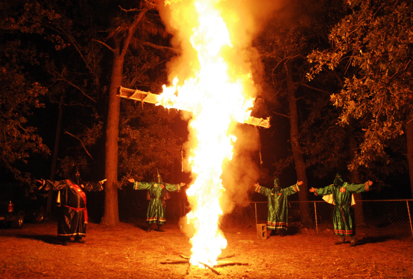 Members of the Ku Klux Klan (KKK) participate in a cross lighting ceremony at a Klansman's home in Warrenville, South Carolina Members of the Ku Klux Klan (KKK) participate in a cross lighting ceremony at a Klansman's home in Warrenville, South Carolina