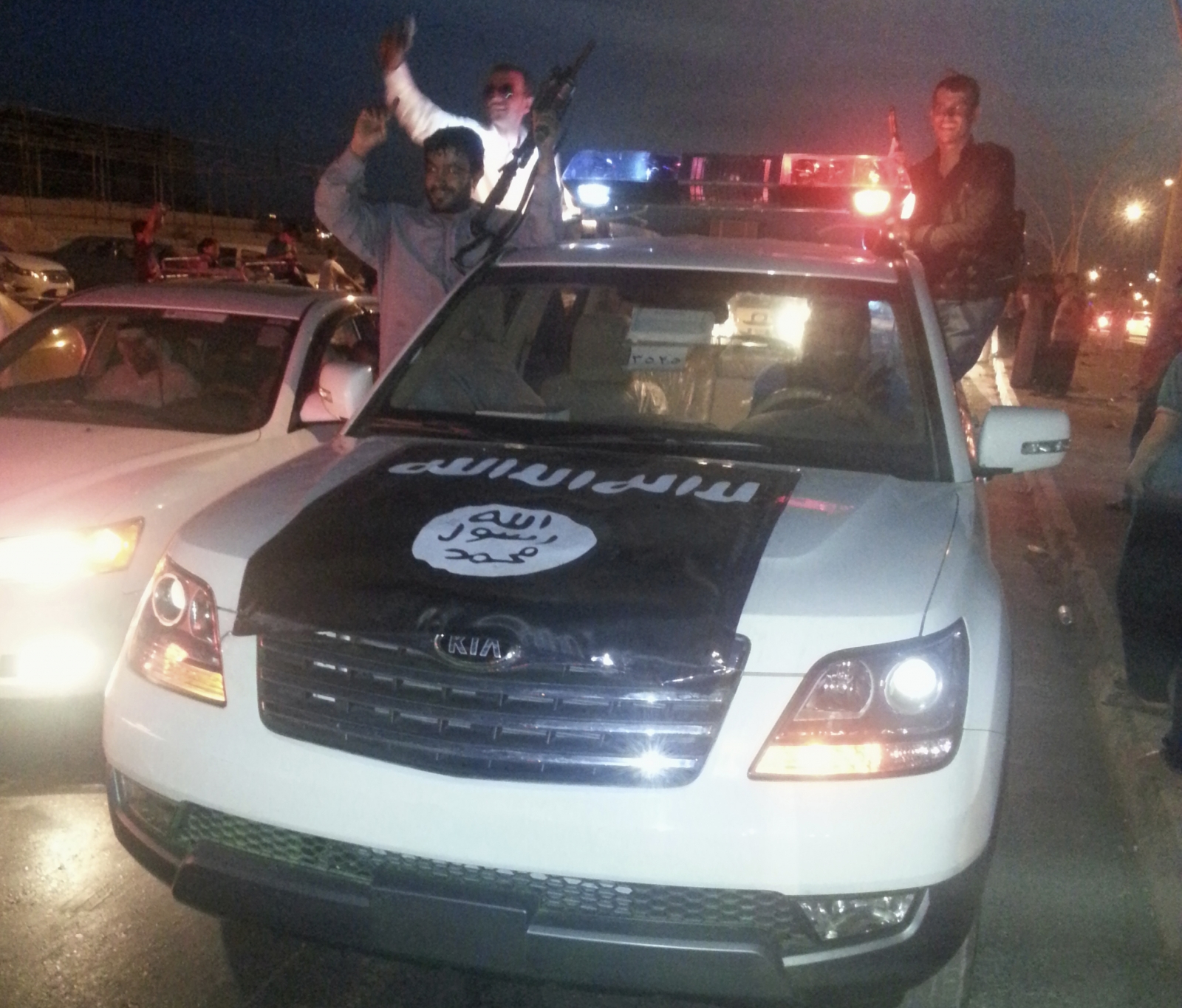 Isis fighters in a commandeered police vehicle in Mosul, Iraq. (Getty)