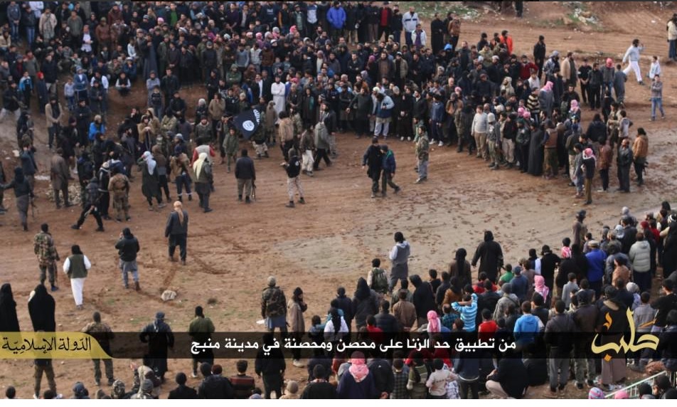 Crowd watch a man and woman being stoned to death for adultery in Manbij, Syria.