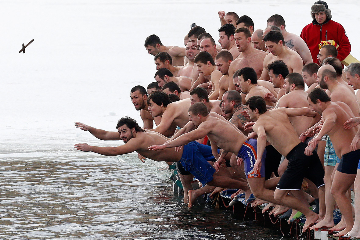 Bulgaria: Men jump into the waters of a lake in Sofia in an attempt to grab a wooden cross on Epiphany Day