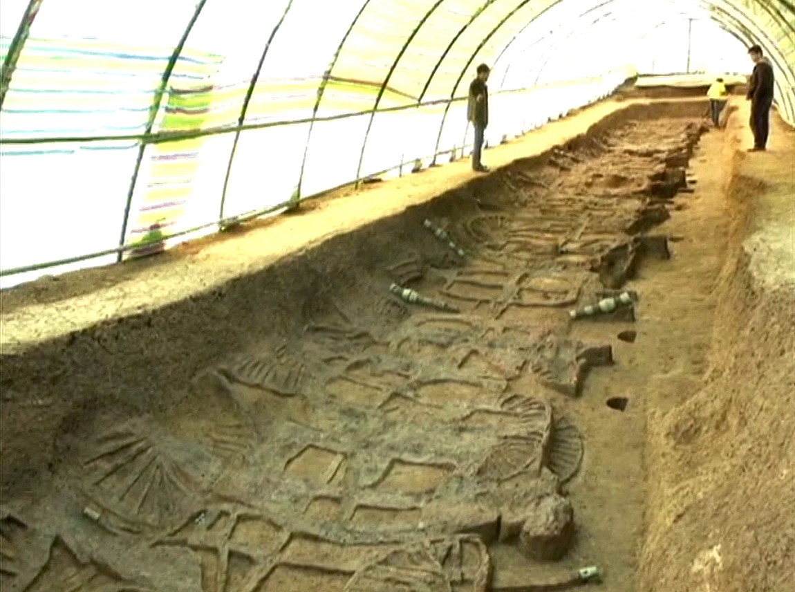 The chariots lie side-by-side in a long pit measuring 33m by 4m The chariots lie side-by-side in a long pit measuring 33m by 4m