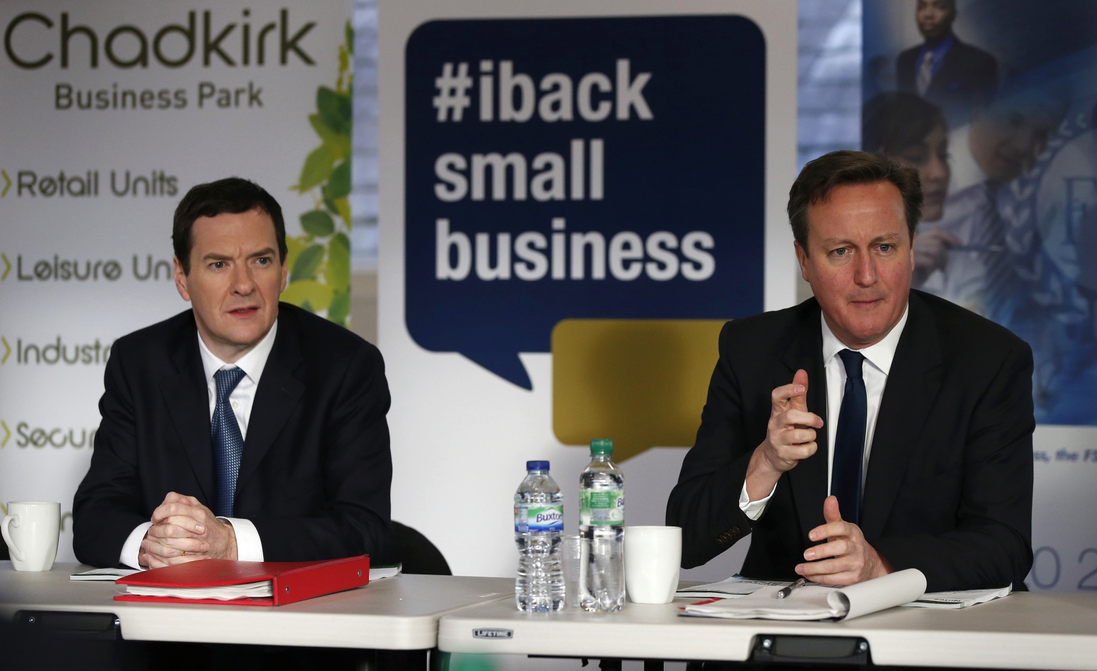 Britain's Prime Minister David Cameron (R) sits with Chancellor George Osborne during a meeting with local small business owners in Stockport, northern England January 9, 2015.