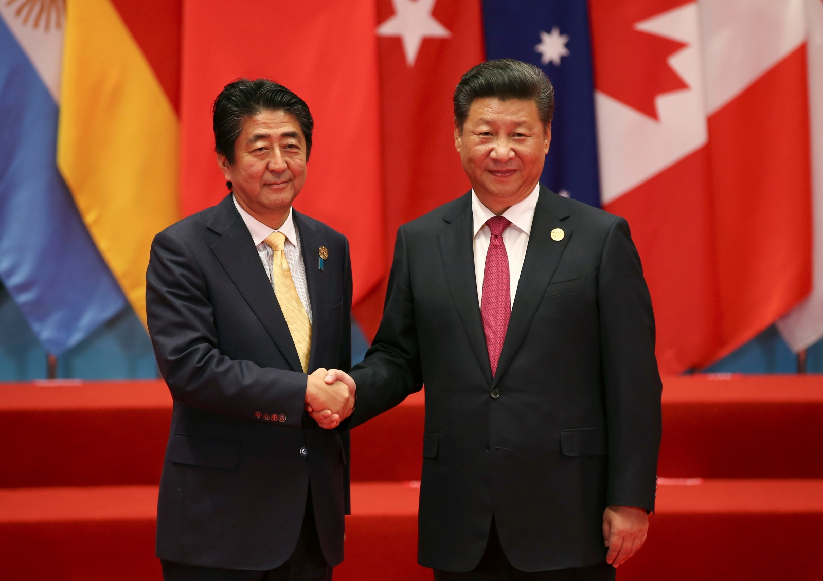 China's Xi Jinping and Japan's Shinzo Abe hold bilateral talks over maritime disputes