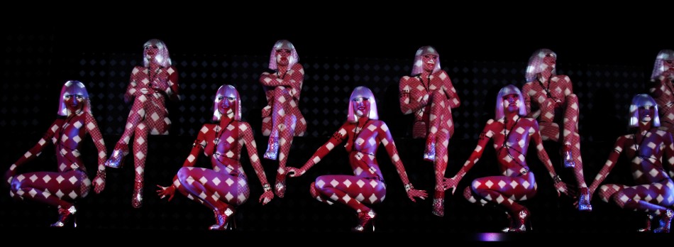 Dancers perform during the press presentation of the new revue named 'Feu' (Fire) directed by designer Christian Louboutin at the Crazy Horse cabaret in Paris February 29, 2012. Picture taken February 29, 2012. Dancers perform during the press presentation of the new revue named 'Feu' directed by designer Christian Louboutin at the Crazy Horse in Paris