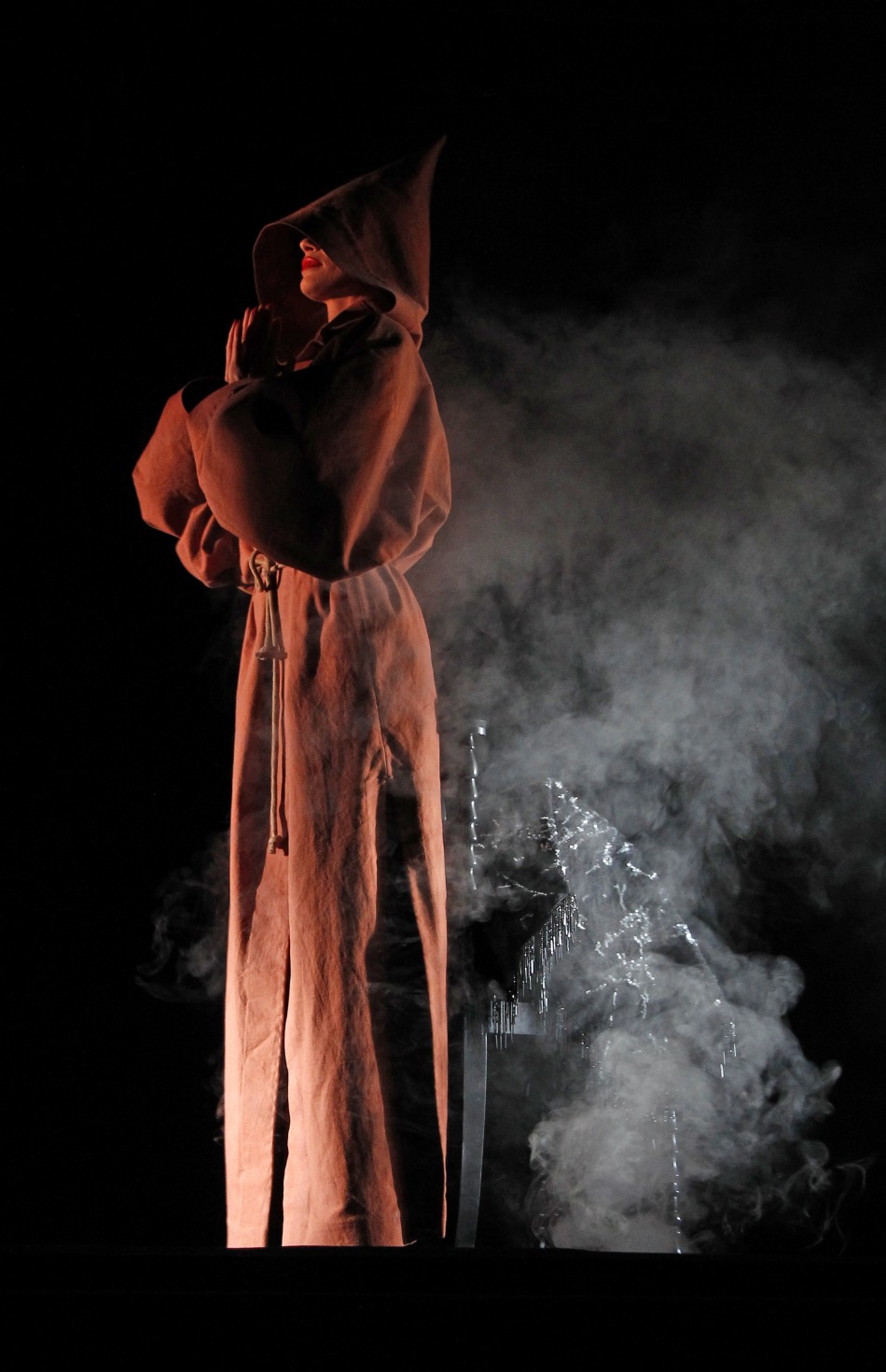 A dancer performs during the press presentation of the new revue named 'Feu' (Fire) directed by designer Christian Louboutin at the Crazy Horse cabaret in Paris February 29, 2012. A dancer performs during the press presentation of the new revue named 'Feu' directed by designer Christian Louboutin at the Crazy Horse in Paris
