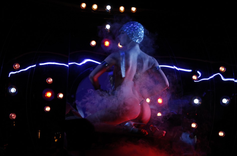 A dancer performs during the press presentation of the new revue named 'Feu' (Fire) directed by designer Christian Louboutin at the Crazy Horse cabaret in Paris February 29, 2012. Picture taken February 29, 2012. A dancer performs during the press presentation of the new revue named 'Feu' directed by designer Christian Louboutin at the Crazy Horse in Paris