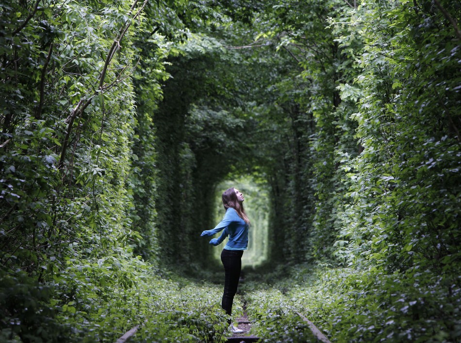 A girl walks on a disused railway track, through what is known locally as the