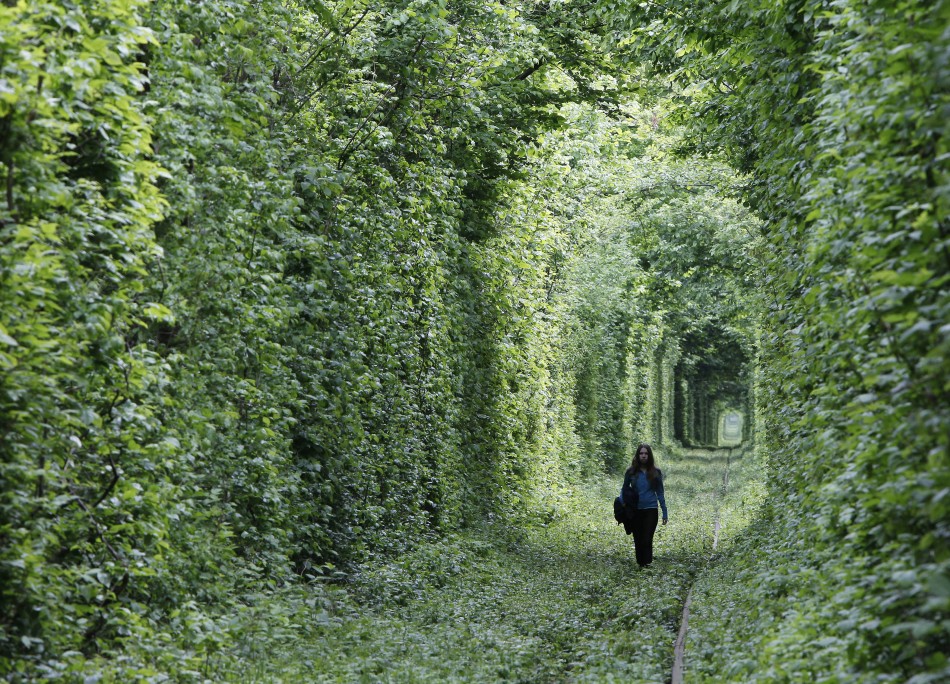 A girl walks on a disused railway track, through what is known locally as the