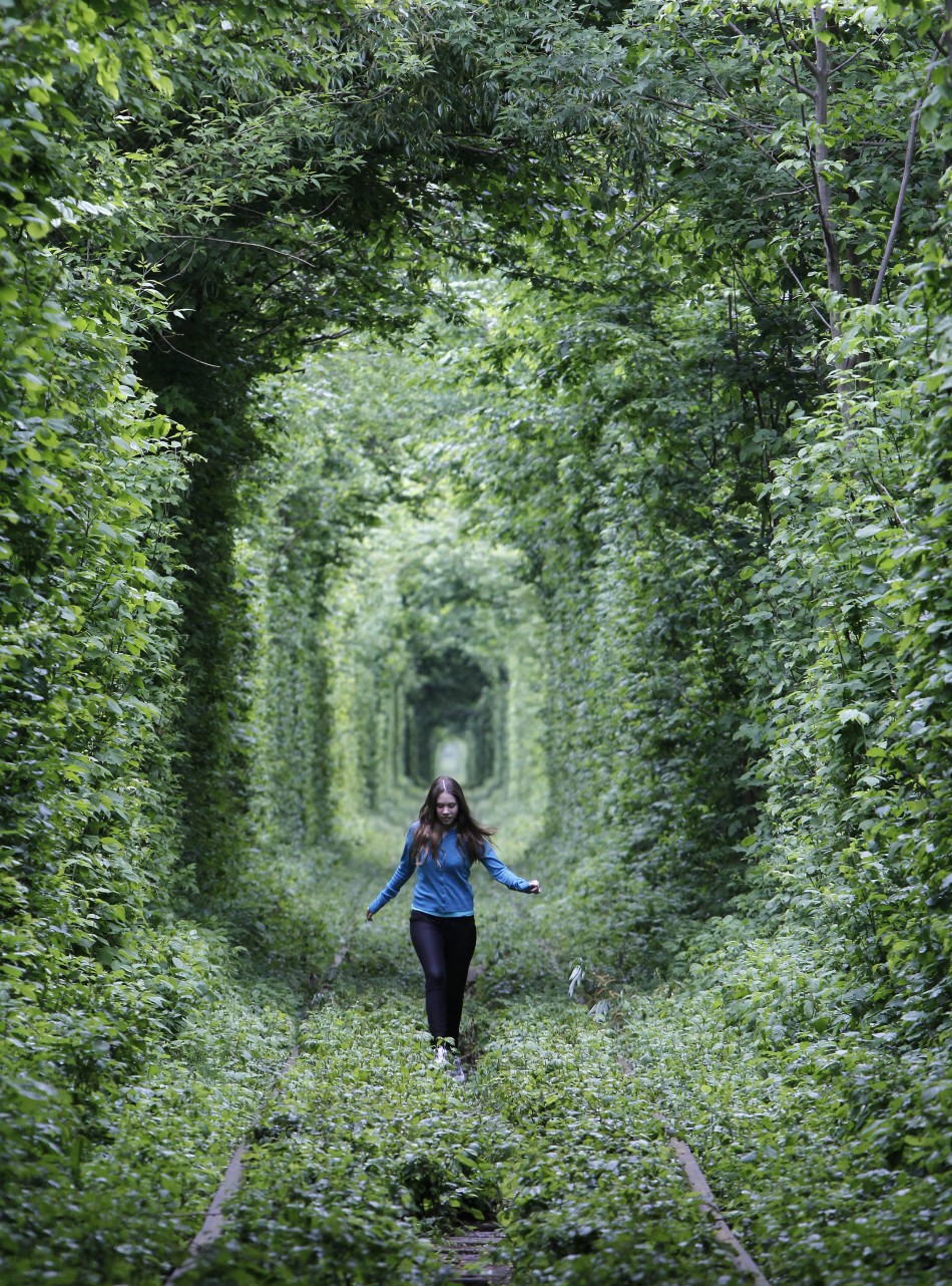 A girl walks on a disused railway track, through what is known locally as the