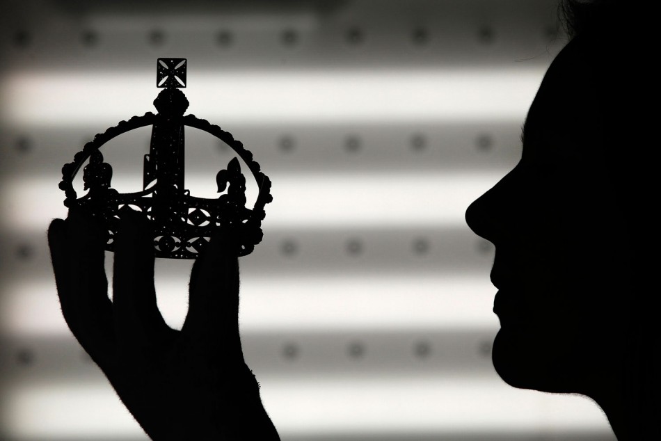 Exhibition curator Caroline de Guitaut poses with Queen Victoria's Small Diamond Crown at the Queen's Gallery in Buckingham Palace, London May 15, 2012. A special exhibition