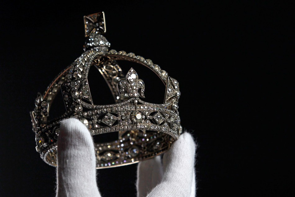 Exhibition curator Caroline de Guitaut poses with Queen Victoria's Small Diamond Crown at the Queen's Gallery in Buckingham Palace, London May 15, 2012. A special exhibition