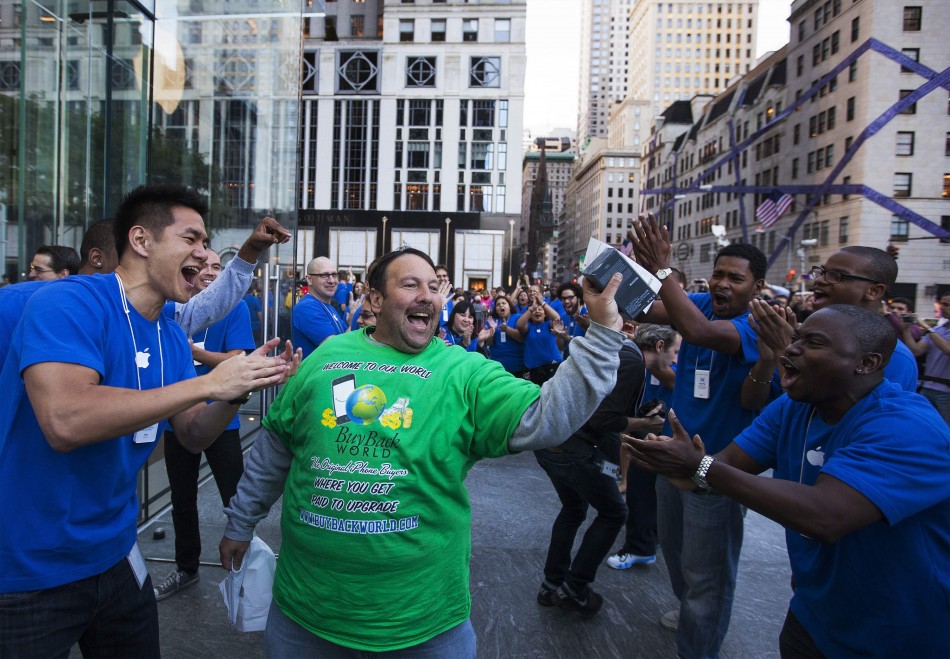 Apple fan Greg Parker departs the Apple Store on 5th Avenue after purchasing an Apple iPhone 5 in New York