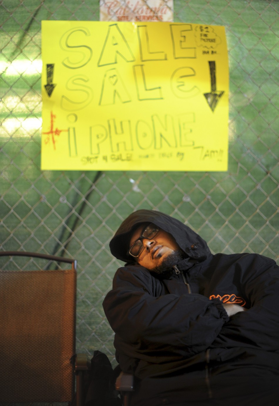 A man, who declined to give his name, sleeps outside an Apple Store shortly before iPhone 5 sales began in San Francisco