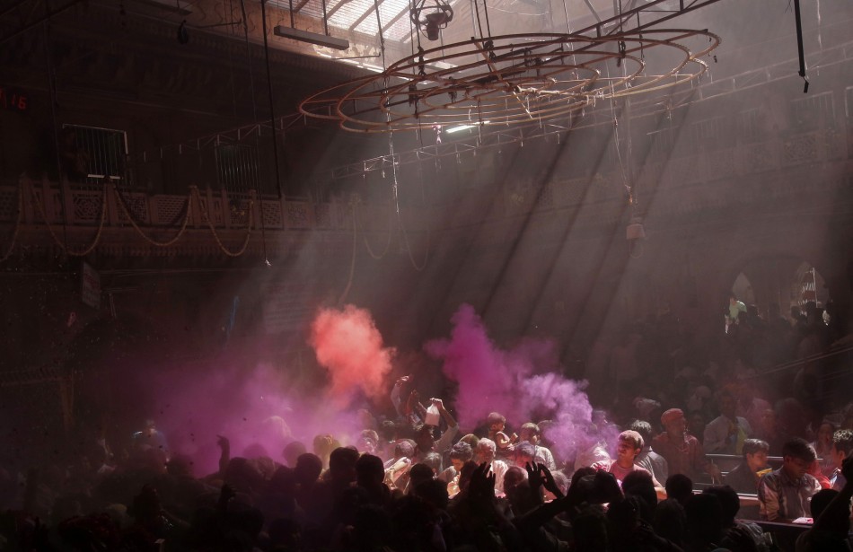 Hindu devotees throw coloured powder into the air during holi celebrations at the Bankey Bihari temple in Vrindavan in the northern Indian state of Uttar Pradesh March 25, 2013. Holi, also known as the Festival of Colours, heralds the beginning of spring and is celebrated all over India.