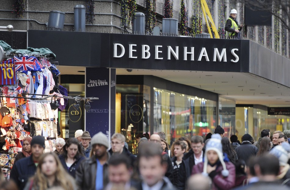 People walk past Debenhams department store on Oxford Street, in ...