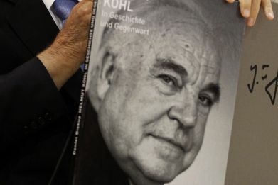Former German Chancellor Helmut Kohl listens to his wife Maike Kohl-Richter during a presentation of a photo book about his life at the book fair in Frankfurt