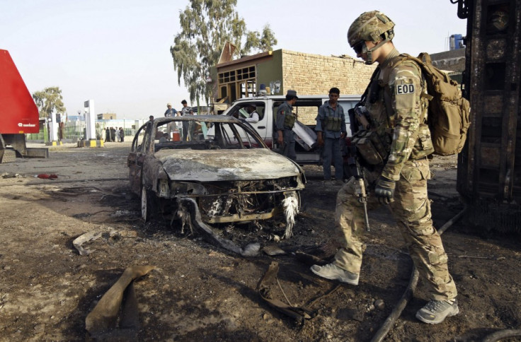 A U.S. soldier walks at the site of suicide attack in Jalalabad A U.S. soldier walks at the site of suicide attack in Jalalabad