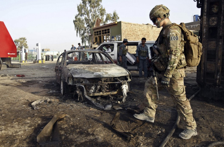 A U.S. soldier walks at the site of suicide attack in Jalalabad