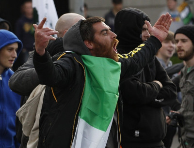 A man taunts Irish police officers during a protest over the visit by the Queen in Dublin. A man taunts Irish police officers during a protest over the visit by the Queen in Dublin.