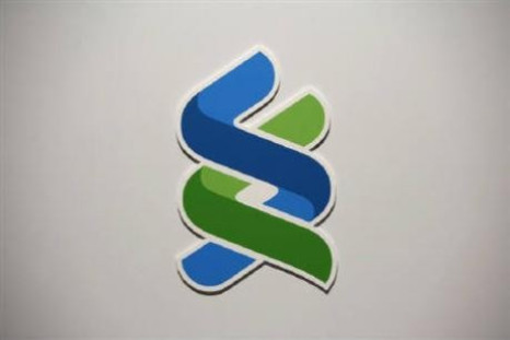 A company logo of Standard Chartered bank is displayed during a news conference in Hong Kong April 29, 2010. 