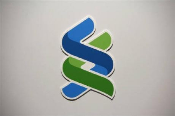 A company logo of Standard Chartered bank is displayed during a news conference in Hong Kong April 29, 2010. 