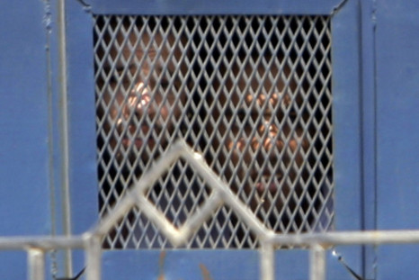 Unidentified suspects look on from inside a vehicle as they they leave the Emergency State Security Court in New Cairo