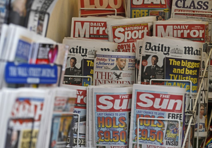 British newspapers are displayed at a newsagent&#039;s stand in central London